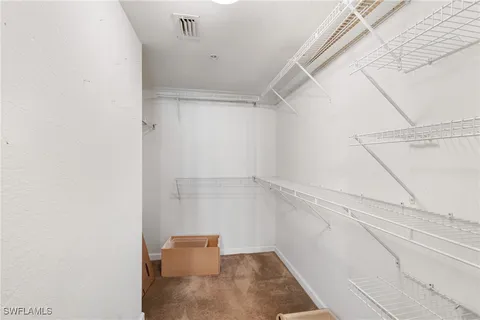 a view of walk in closet with clothes