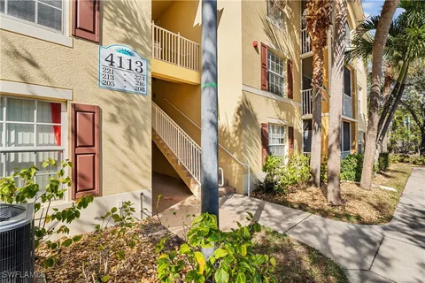 a view of a street with potted plants