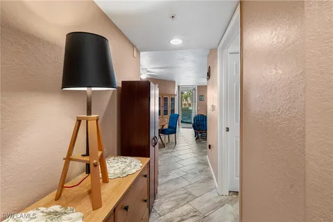 a walk in closet with wooden floor