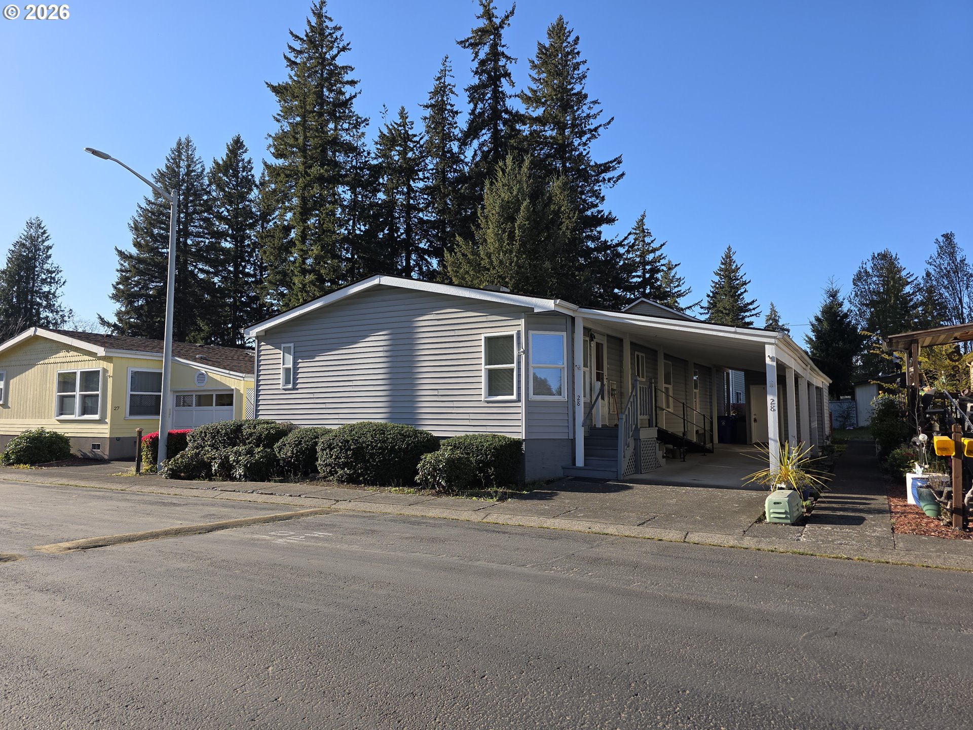 15768 Southeast Powell Boulevard, Unit 28 Portland, OR 97236 - Photo 1 of 42 a front view of a house with a yard