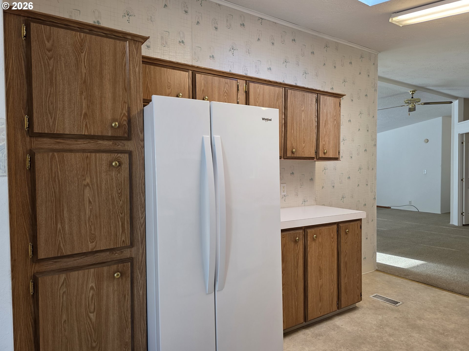 15768 Southeast Powell Boulevard, Unit 28 Portland, OR 97236 - Photo 13 of 42 a white refrigerator freezer sitting in a kitchen