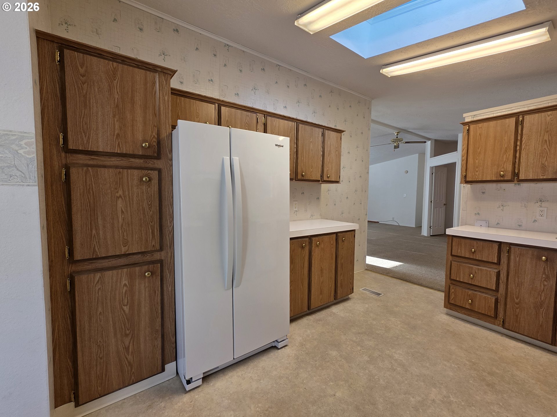 15768 Southeast Powell Boulevard, Unit 28 Portland, OR 97236 - Photo 14 of 42 a kitchen with stainless steel appliances a refrigerator and cabinets