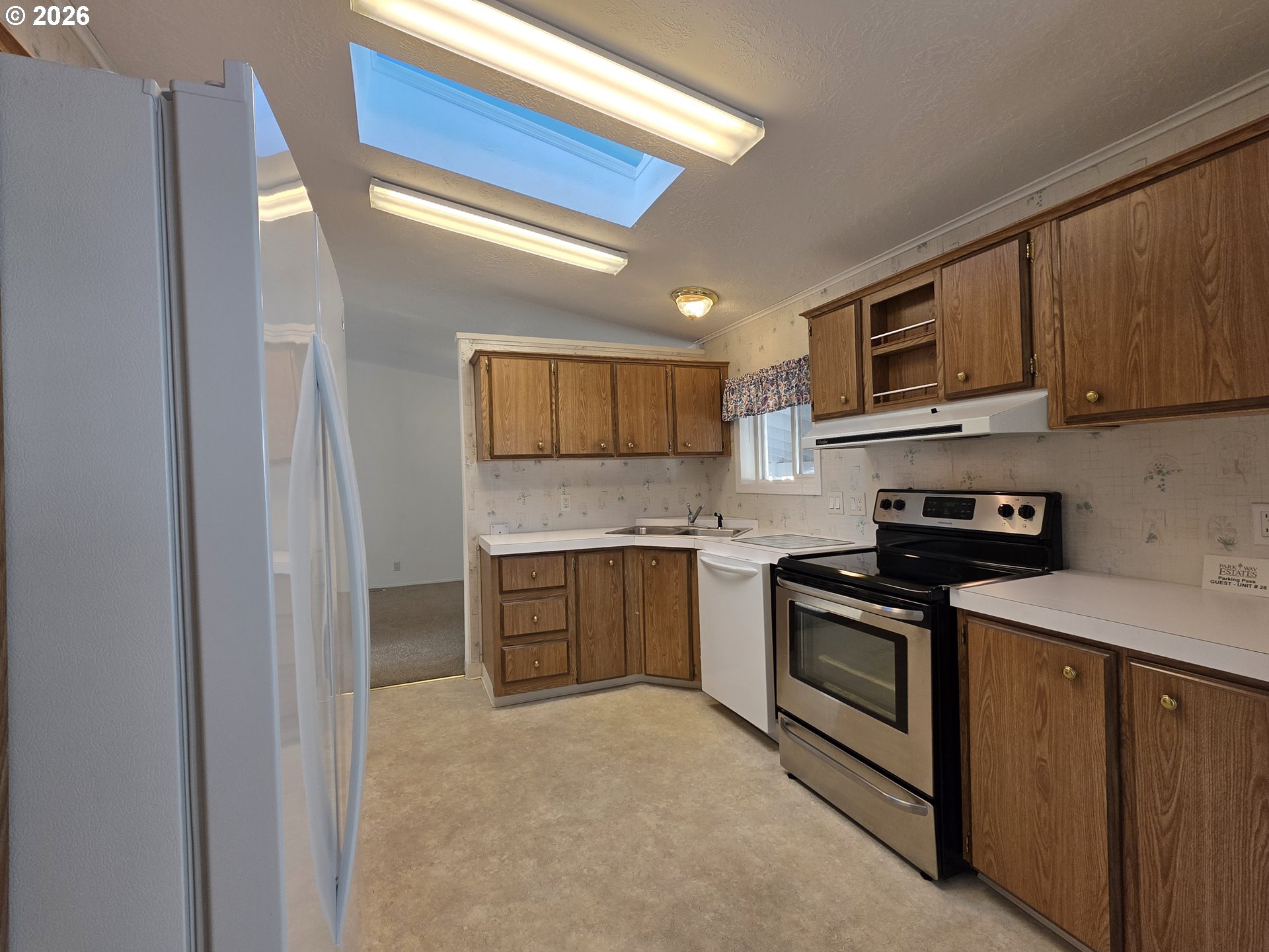 15768 Southeast Powell Boulevard, Unit 28 Portland, OR 97236 - Photo 15 of 42 a kitchen with stainless steel appliances granite countertop a stove sink and cabinets