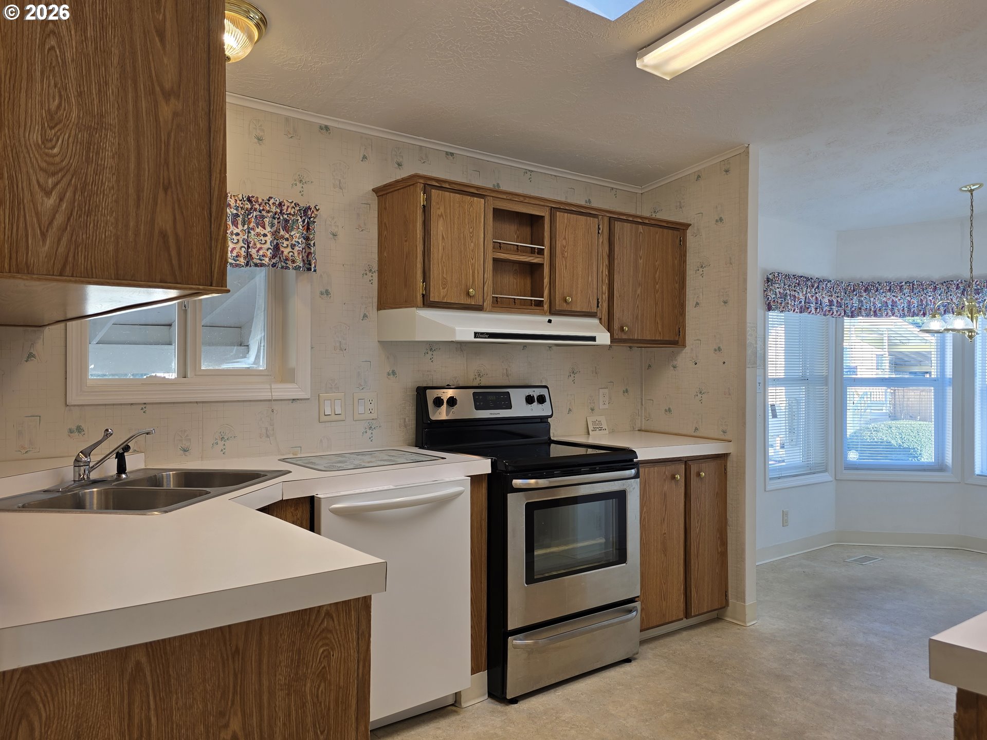 15768 Southeast Powell Boulevard, Unit 28 Portland, OR 97236 - Photo 18 of 42 a kitchen with a sink stove and microwave