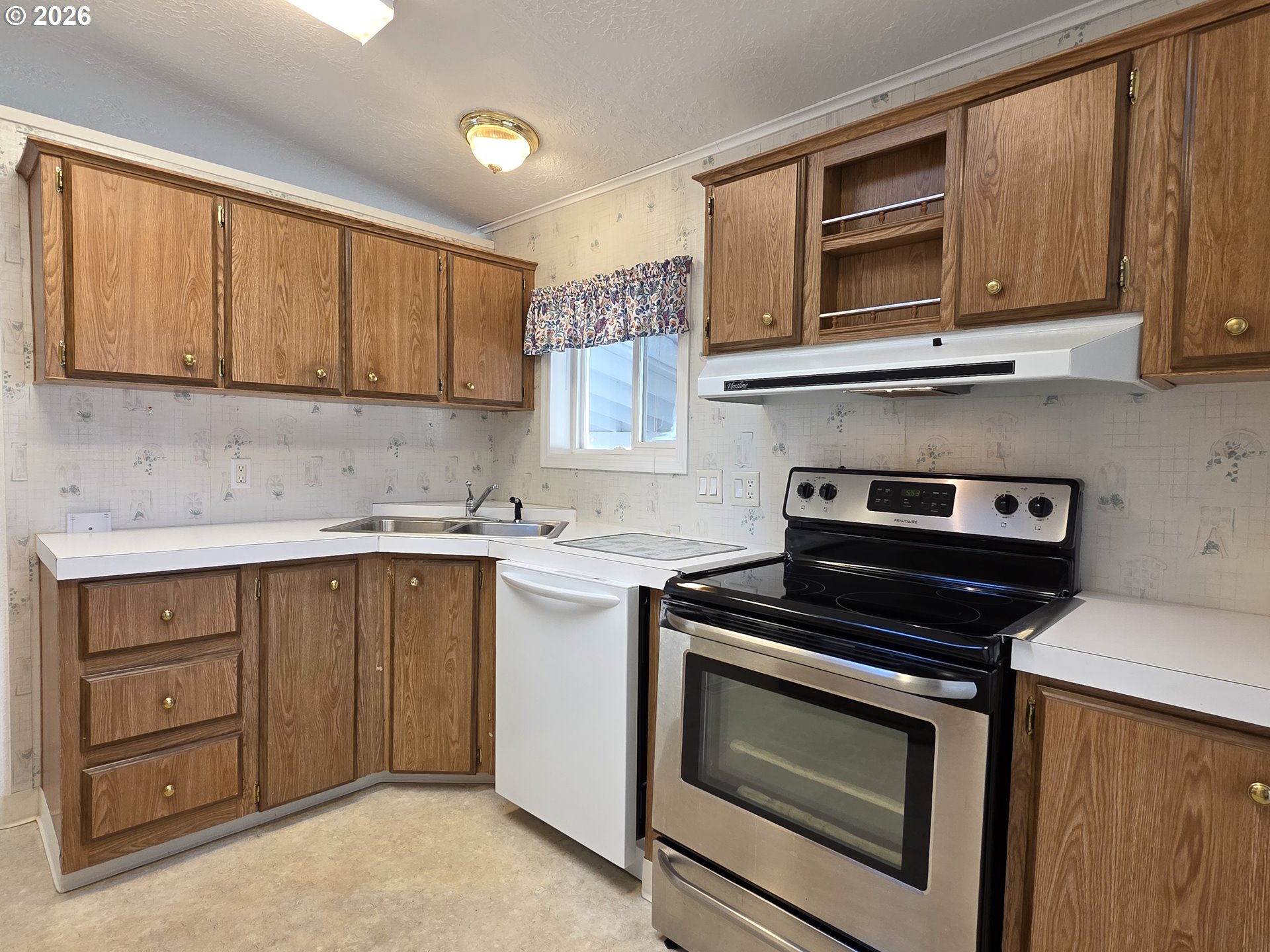15768 Southeast Powell Boulevard, Unit 28 Portland, OR 97236 - Photo 19 of 42 a kitchen with stainless steel appliances granite countertop a stove microwave and cabinets
