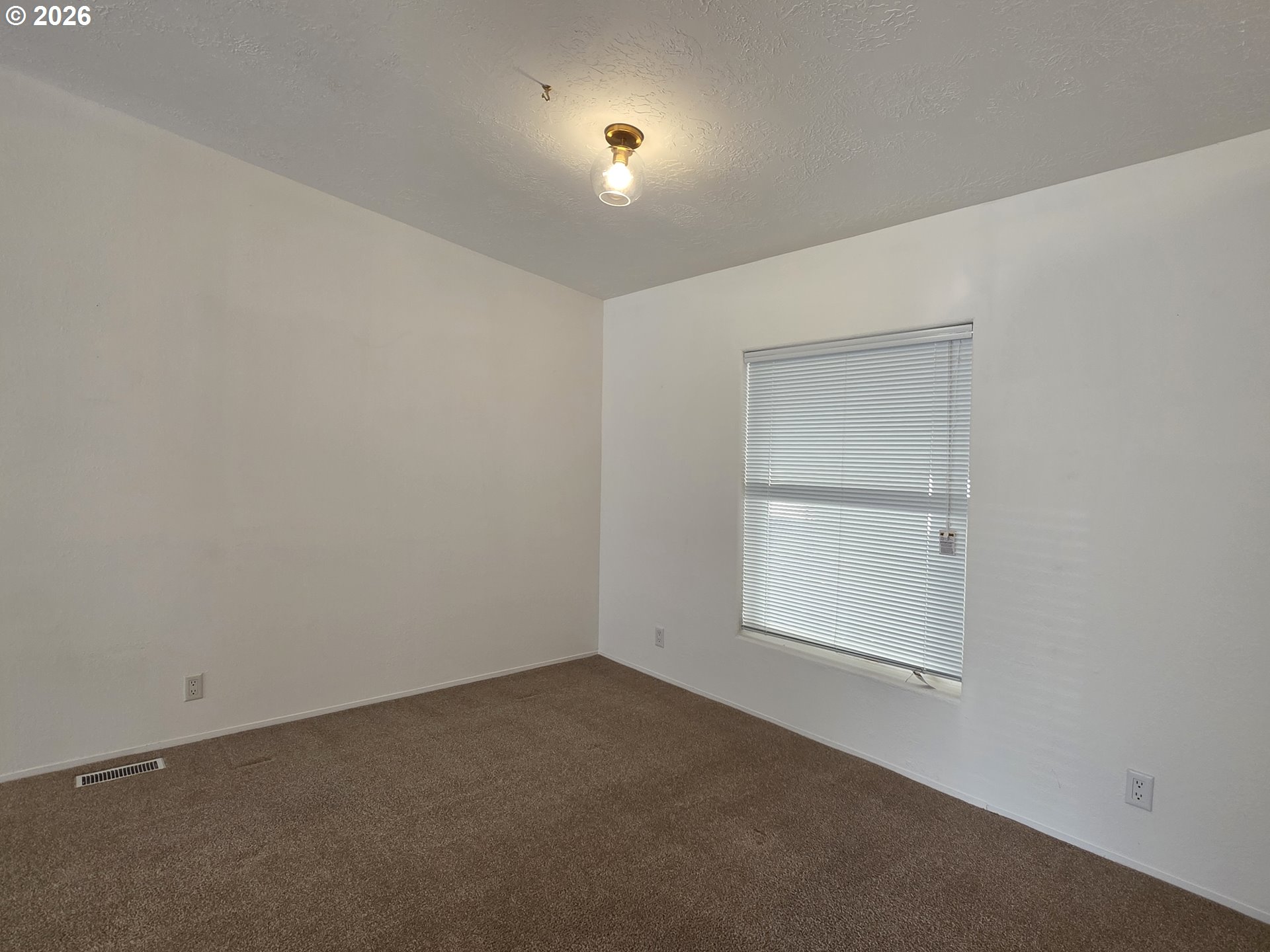 15768 Southeast Powell Boulevard, Unit 28 Portland, OR 97236 - Photo 20 of 42 an empty room with a window