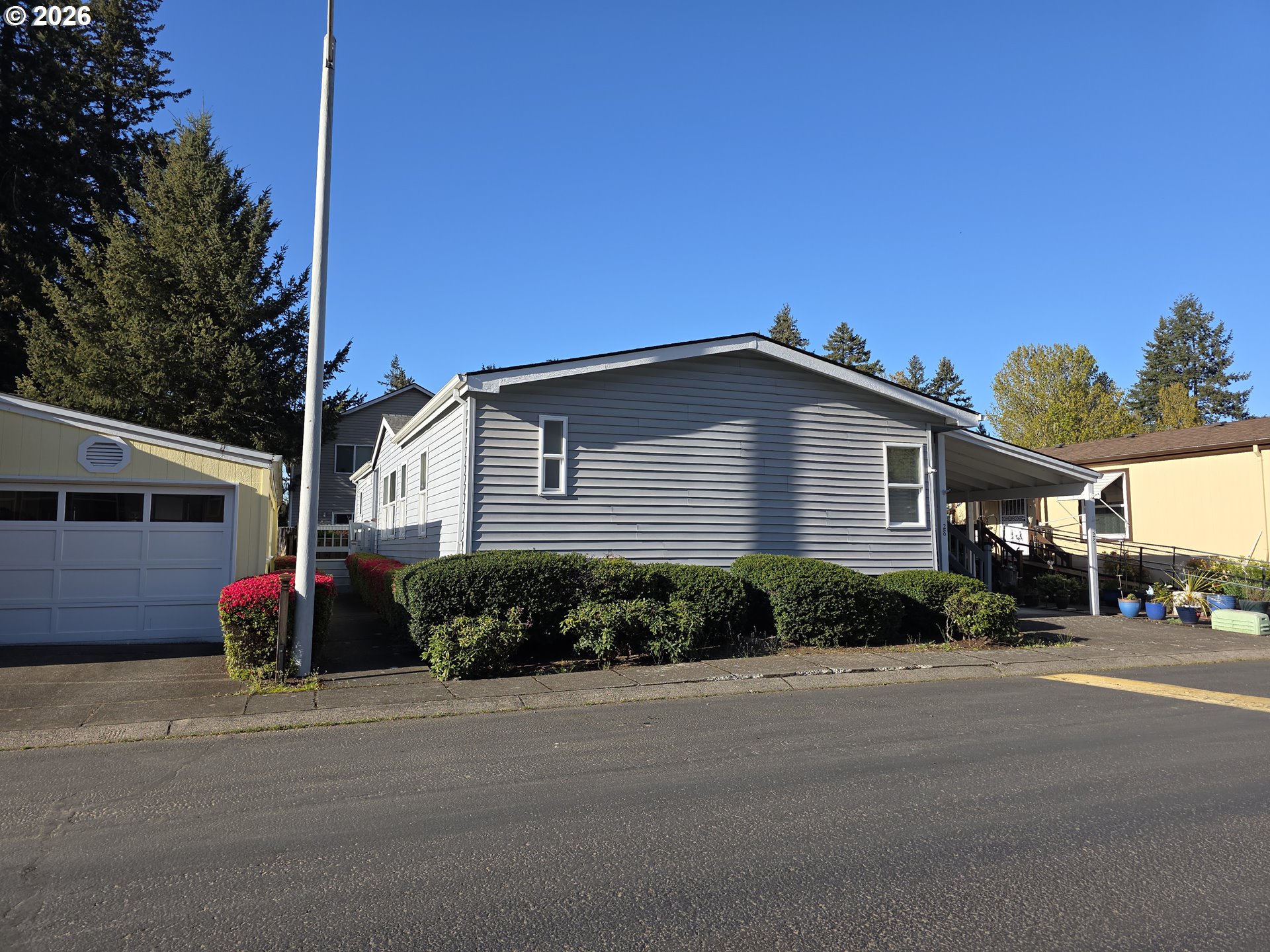 15768 Southeast Powell Boulevard, Unit 28 Portland, OR 97236 - Photo 2 of 42 a front view of a house with a yard