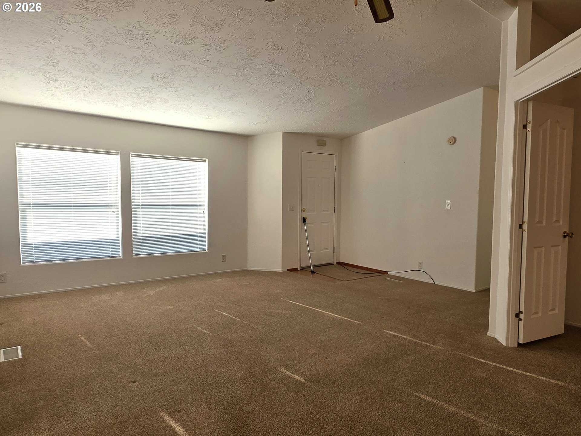 15768 Southeast Powell Boulevard, Unit 28 Portland, OR 97236 - Photo 21 of 42 an empty room with windows
