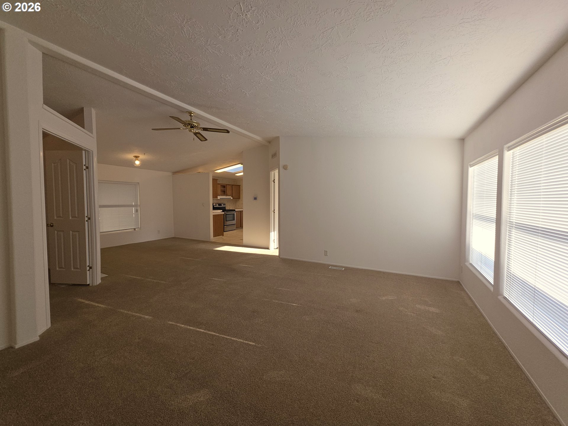 15768 Southeast Powell Boulevard, Unit 28 Portland, OR 97236 - Photo 24 of 42 a view of a big room with windows and chandelier