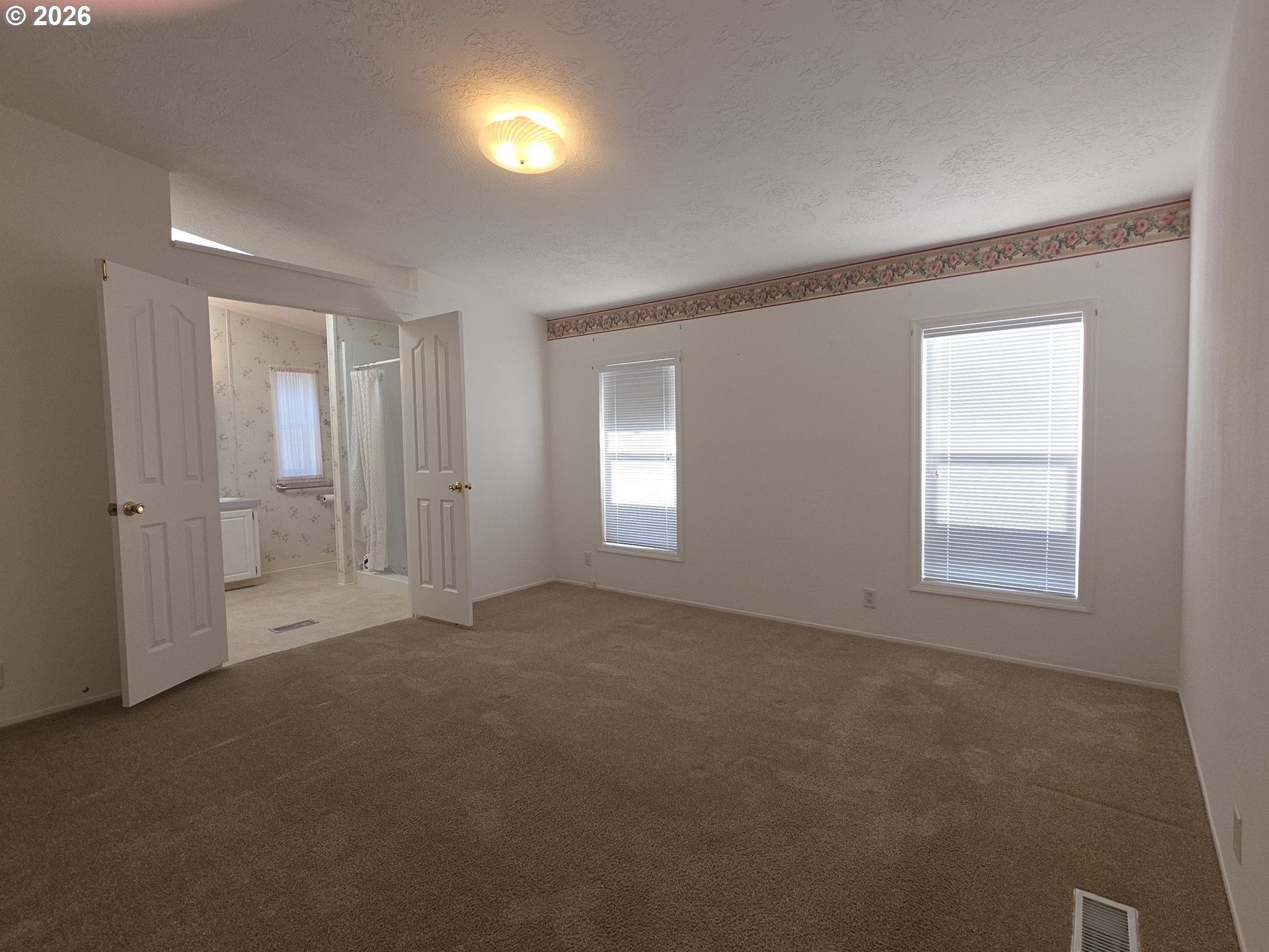 15768 Southeast Powell Boulevard, Unit 28 Portland, OR 97236 - Photo 28 of 42 an empty room with windows