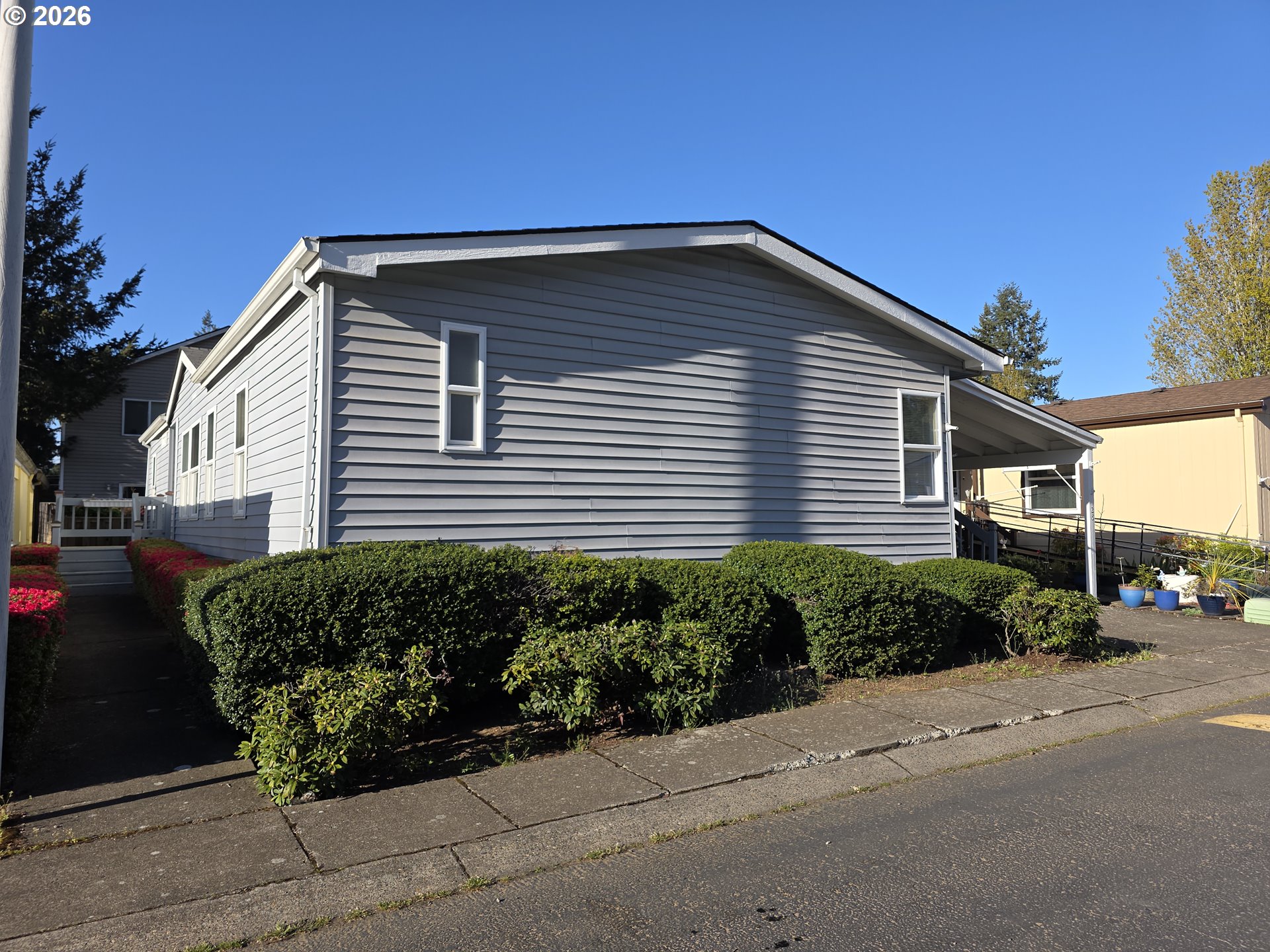 15768 Southeast Powell Boulevard, Unit 28 Portland, OR 97236 - Photo 3 of 42 a front view of a house with a yard