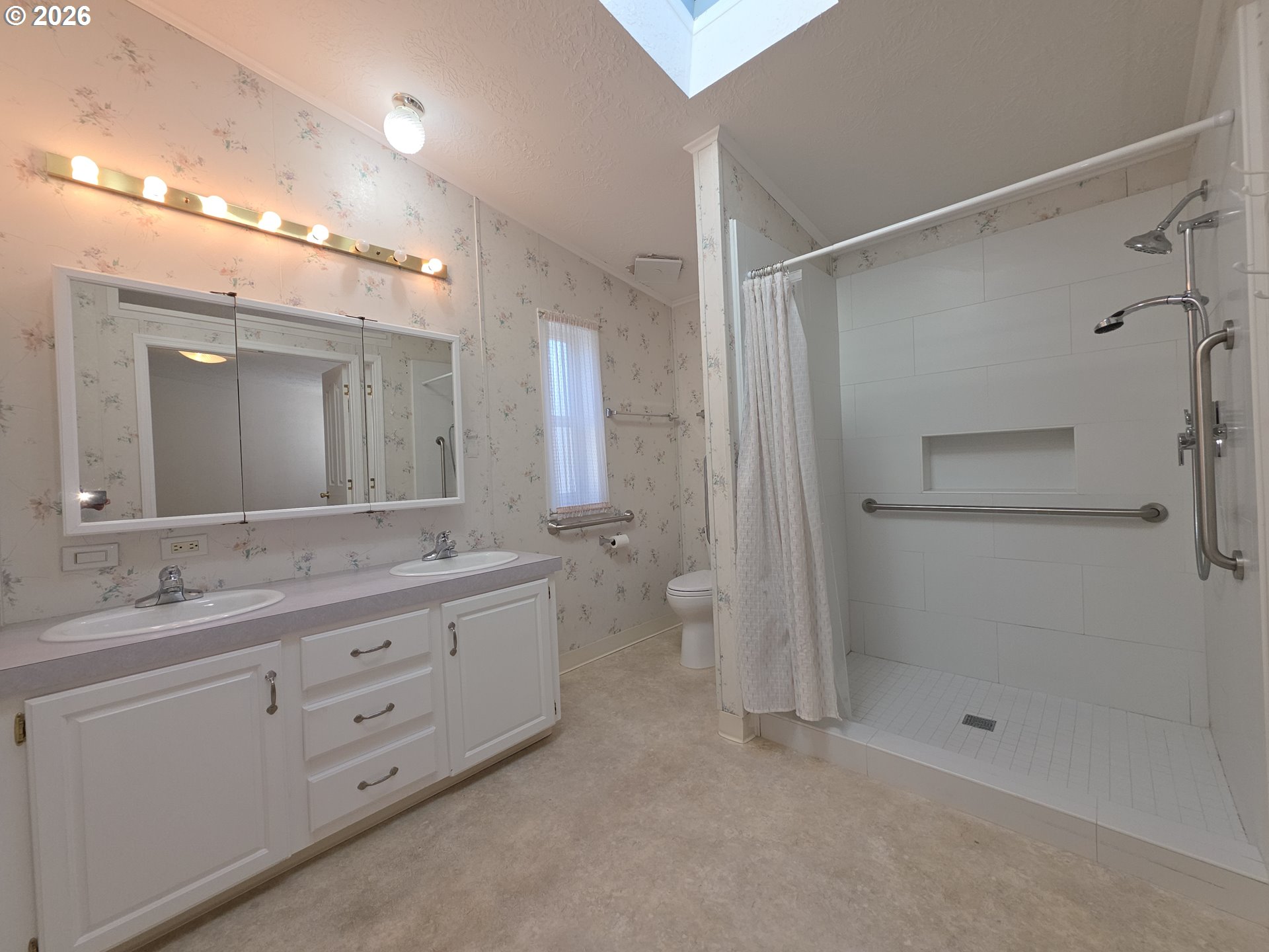 15768 Southeast Powell Boulevard, Unit 28 Portland, OR 97236 - Photo 31 of 42 a bathroom with a double vanity sink toilet and shower