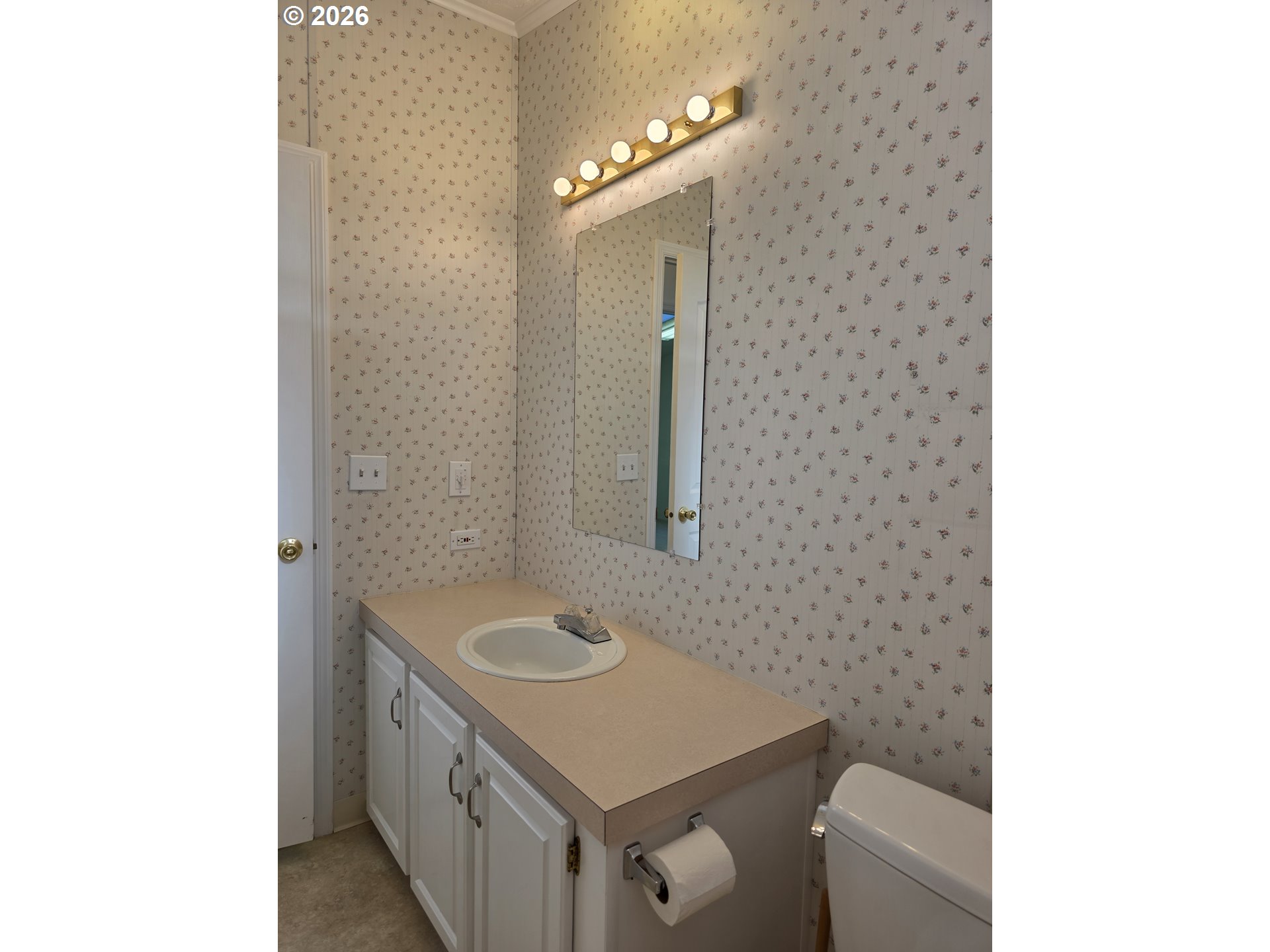 15768 Southeast Powell Boulevard, Unit 28 Portland, OR 97236 - Photo 39 of 42 a bathroom with a sink a toilet and mirror