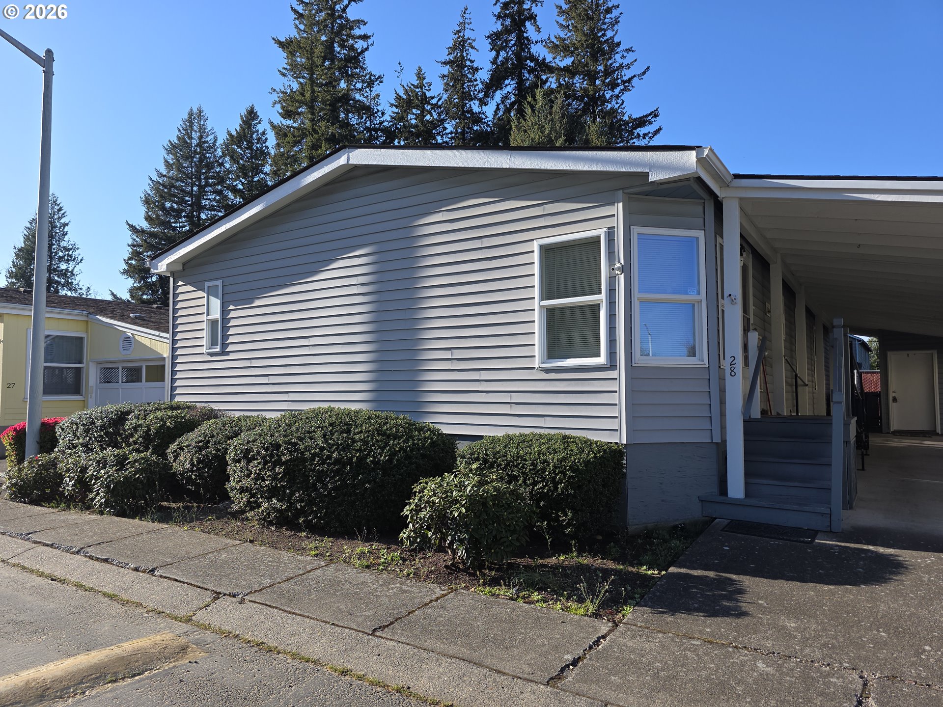15768 Southeast Powell Boulevard, Unit 28 Portland, OR 97236 - Photo 4 of 42 a view of a house with a yard