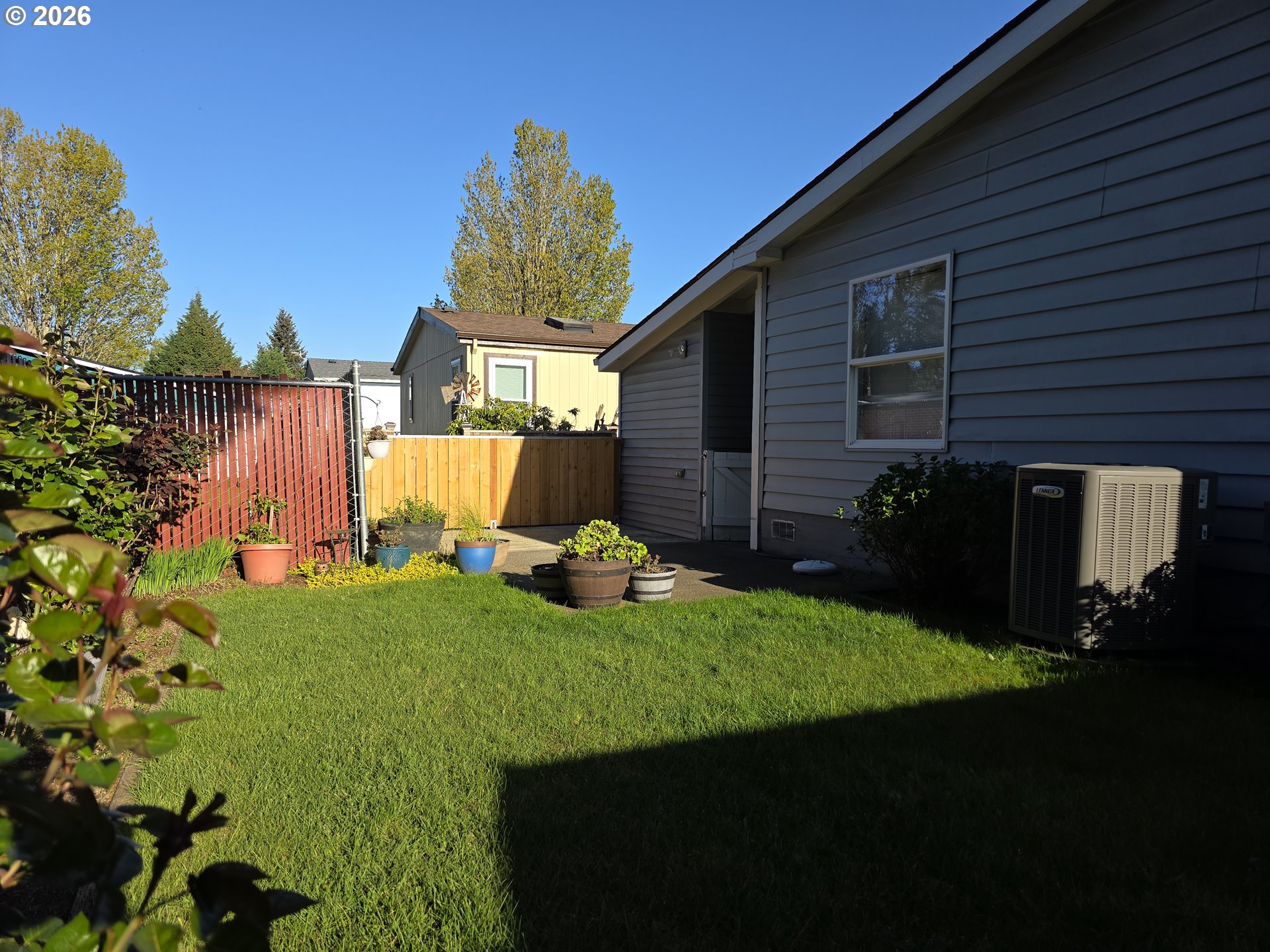 15768 Southeast Powell Boulevard, Unit 28 Portland, OR 97236 - Photo 6 of 42 a view of a backyard with plants and a patio