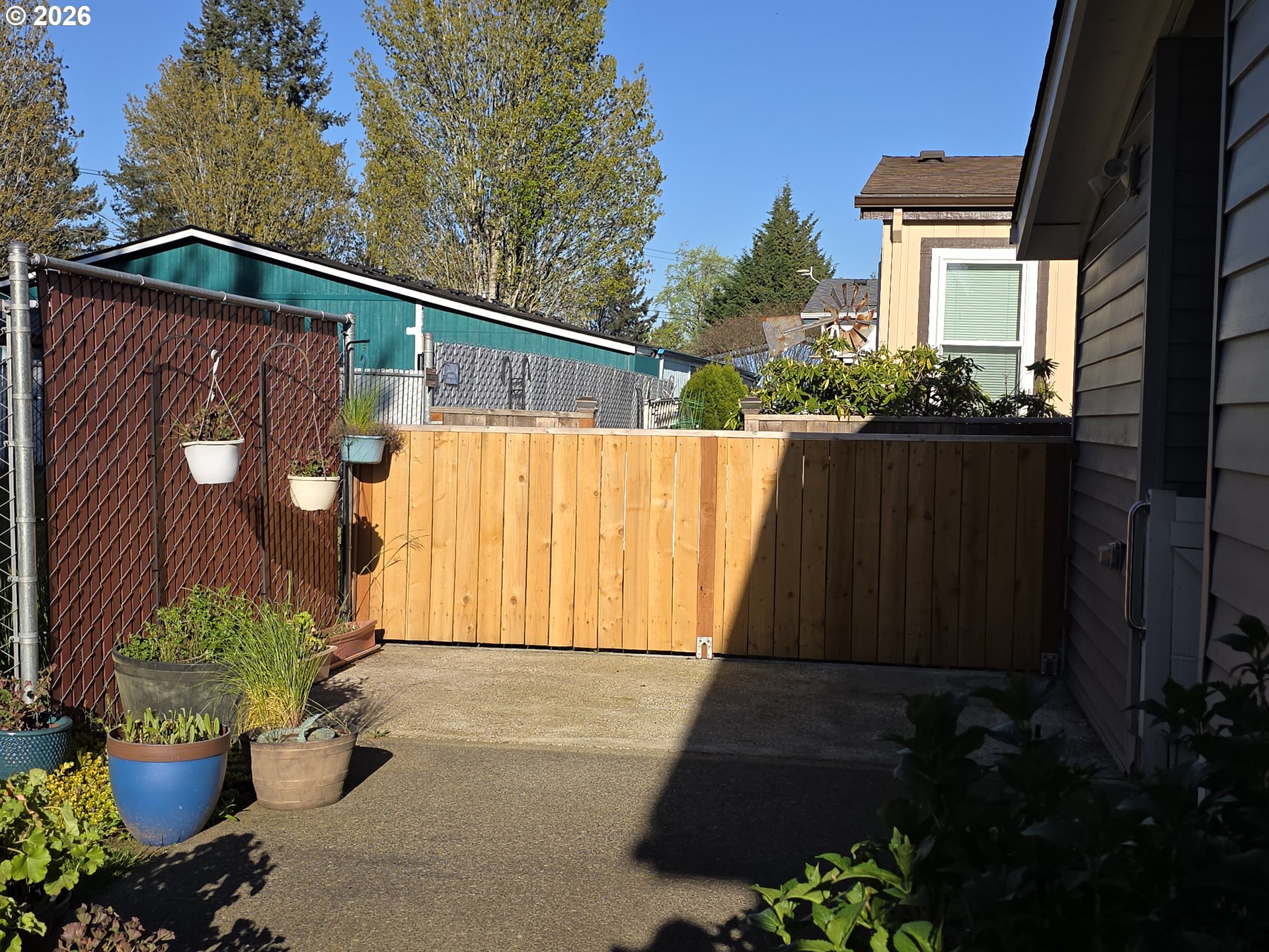 15768 Southeast Powell Boulevard, Unit 28 Portland, OR 97236 - Photo 8 of 42 a view of a house with a wooden fence