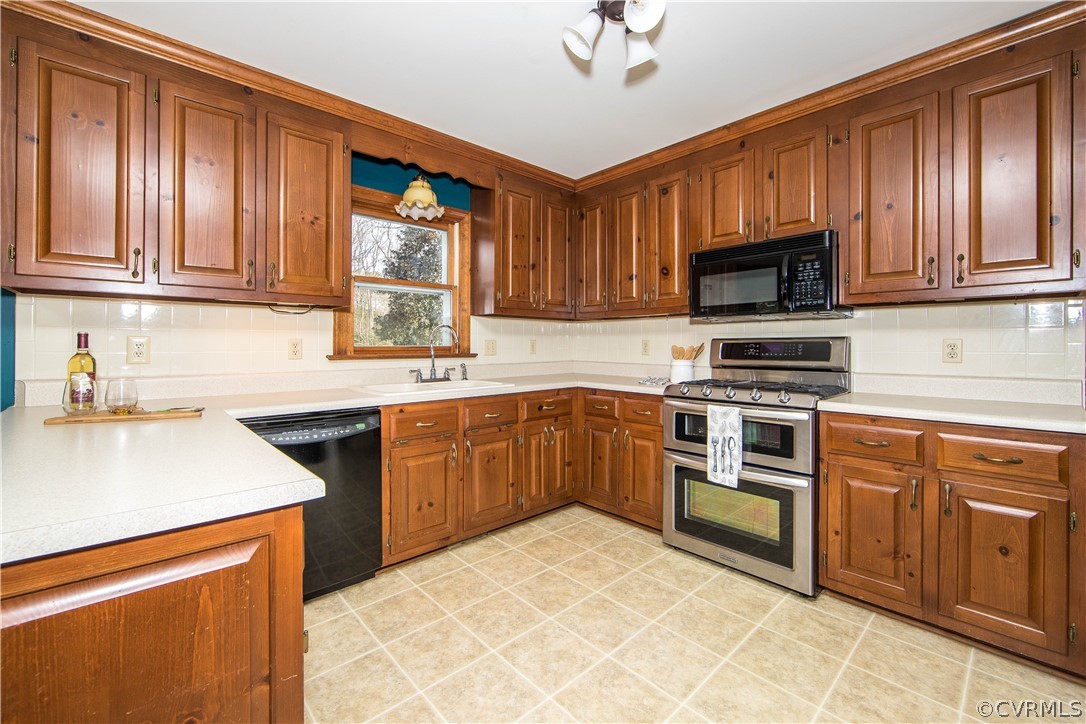 12905 Rivers Bend Road Chester, VA 23836 - Photo 10 of 27 The kitchen features wood cabinetry, a double oven
