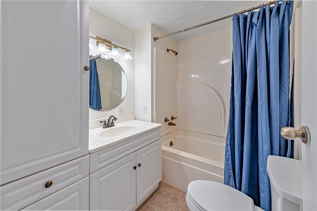 3018 Richey Road Connellsville, PA 15425 - Photo 14 of 27 a bathroom with a tub toilet sink mirror and vanity