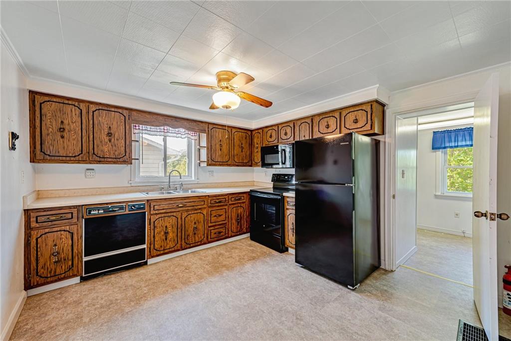 3018 Richey Road Connellsville, PA 15425 - Photo 8 of 27 a kitchen with stainless steel appliances granite countertop a refrigerator a stove top oven and a sink
