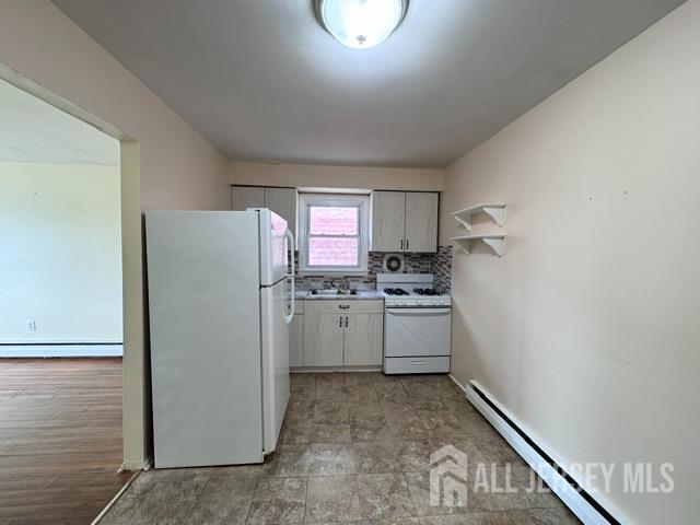 760 Mary Street, Unit B Perth Amboy, NJ 08861 - Photo 4 of 10 a kitchen with a refrigerator and white cabinets