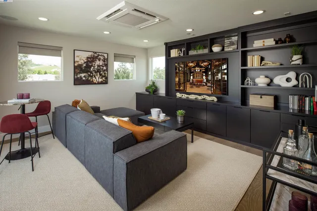 a living room with furniture a window and bookshelf