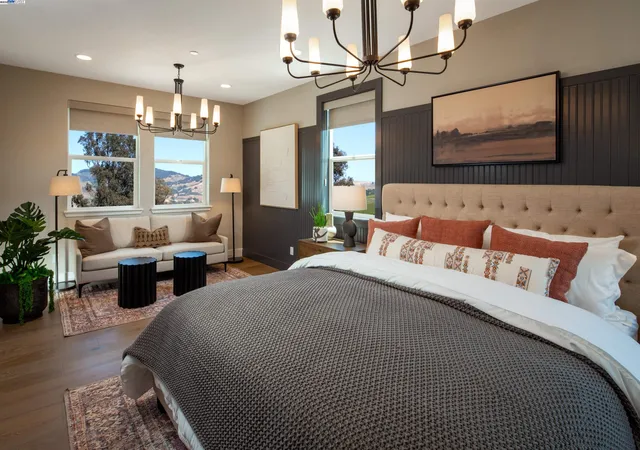 a bedroom with furniture a ceiling fan and a rug