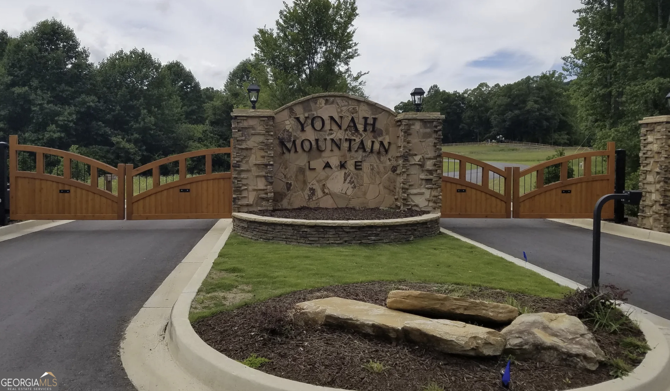 0 Waterfall Lane Sautee Nacoochee, GA 30571 - Photo 2 of 12 a view of a garden with a houses in the background