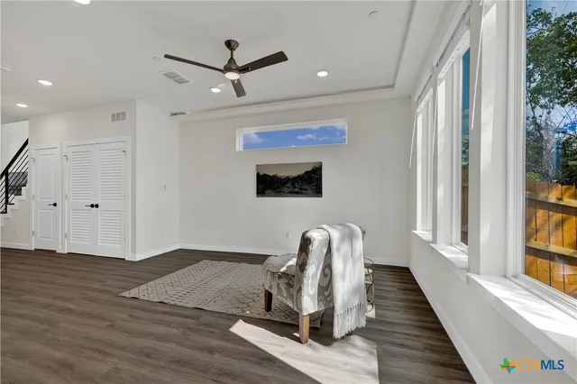 a living room with wooden floor furniture and a window