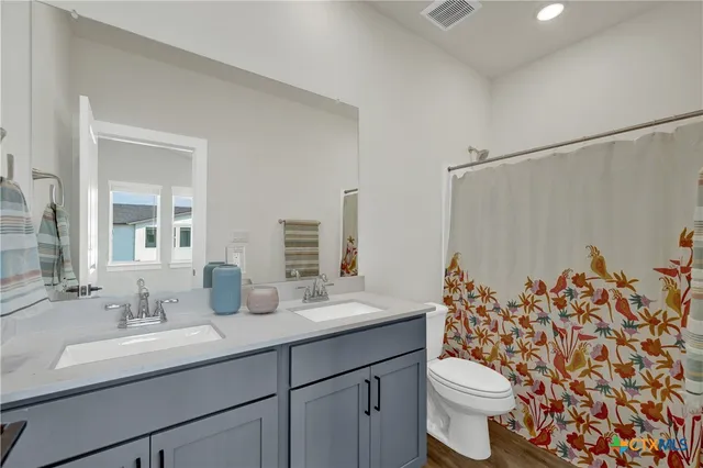a view of a workspace with furniture and wooden floor