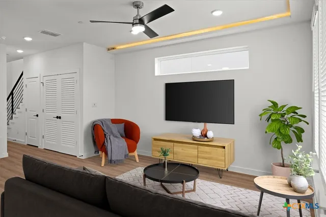 a living room with furniture and wooden floor