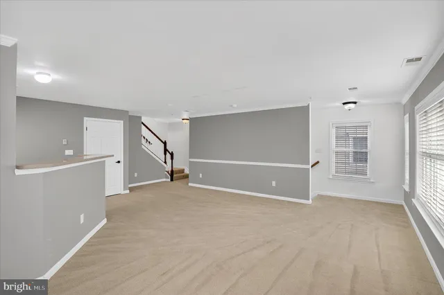 a view of kitchen with window and refrigerator