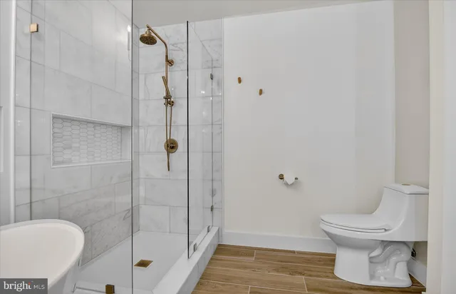 a bathroom with a double vanity sink mirror and bathtub