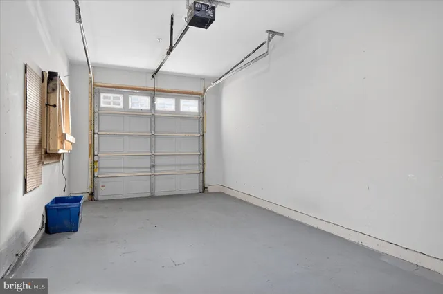 a view of an empty room with cabinet and a window