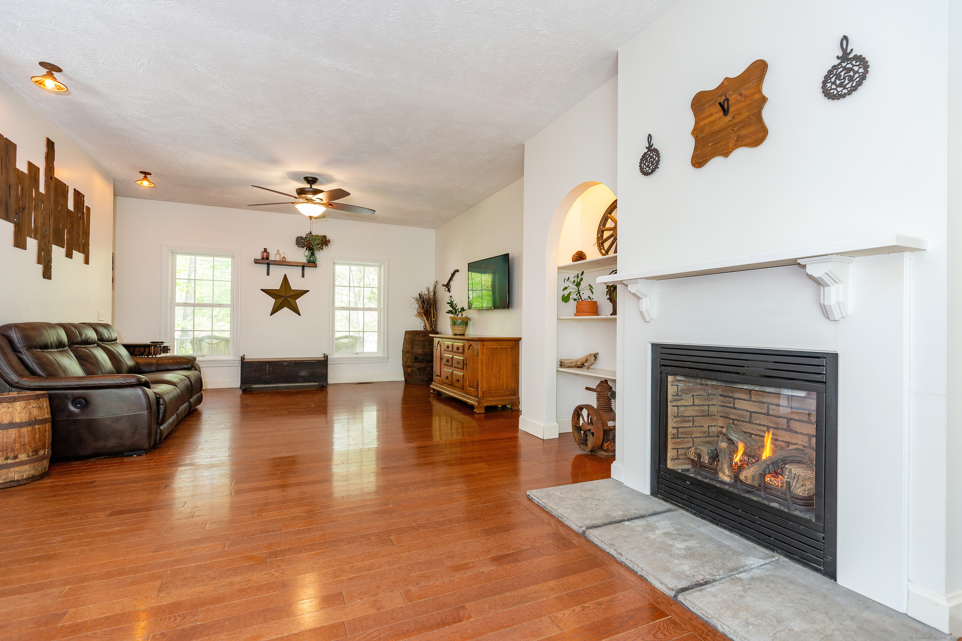 127 Massapeag Road Montville, CT 06382 - Photo 11 of 39 a living room with furniture and a fireplace