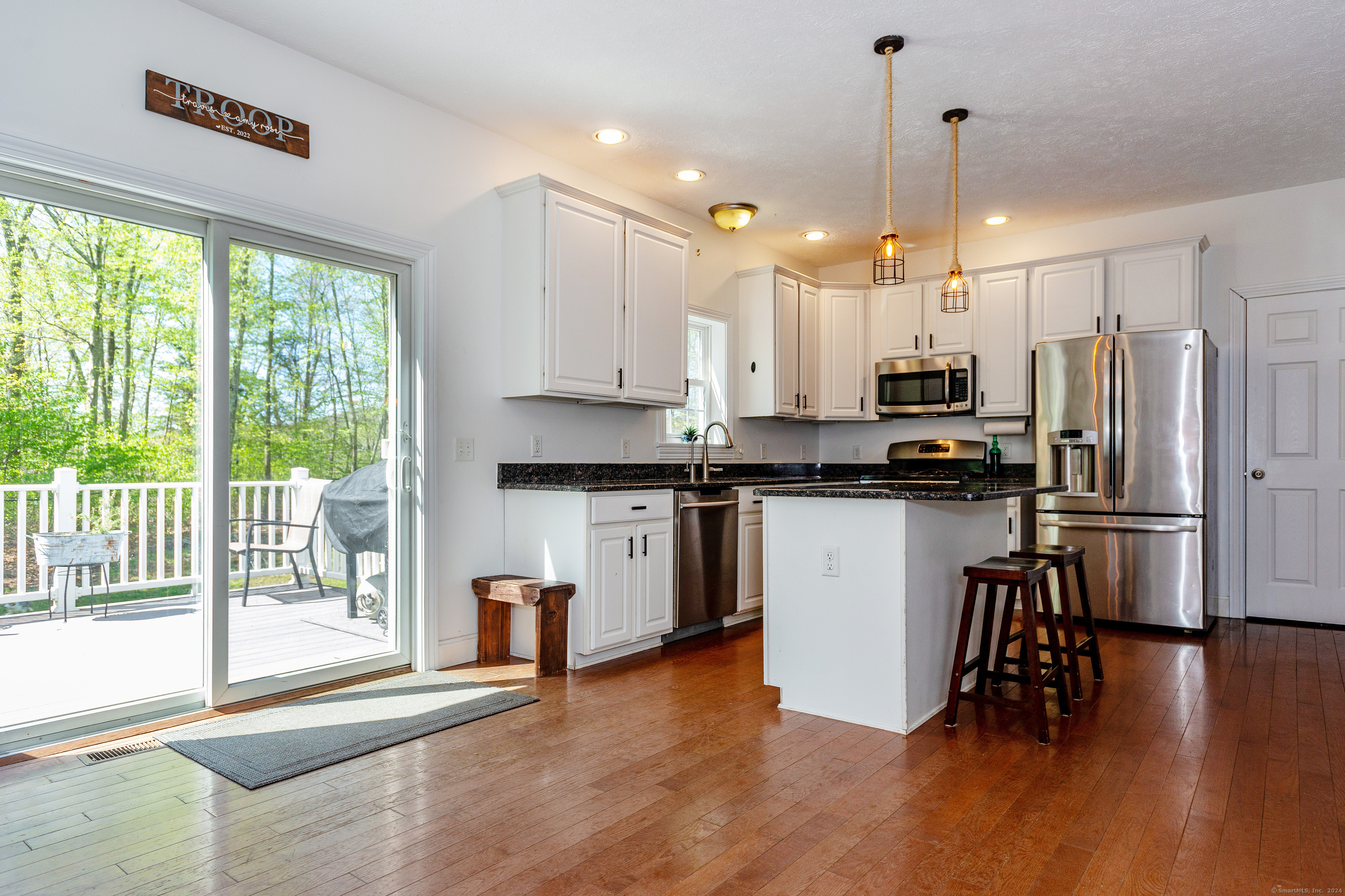 127 Massapeag Road Montville, CT 06382 - Photo 12 of 39 a kitchen with kitchen island granite countertop a refrigerator a stove a sink and a large window