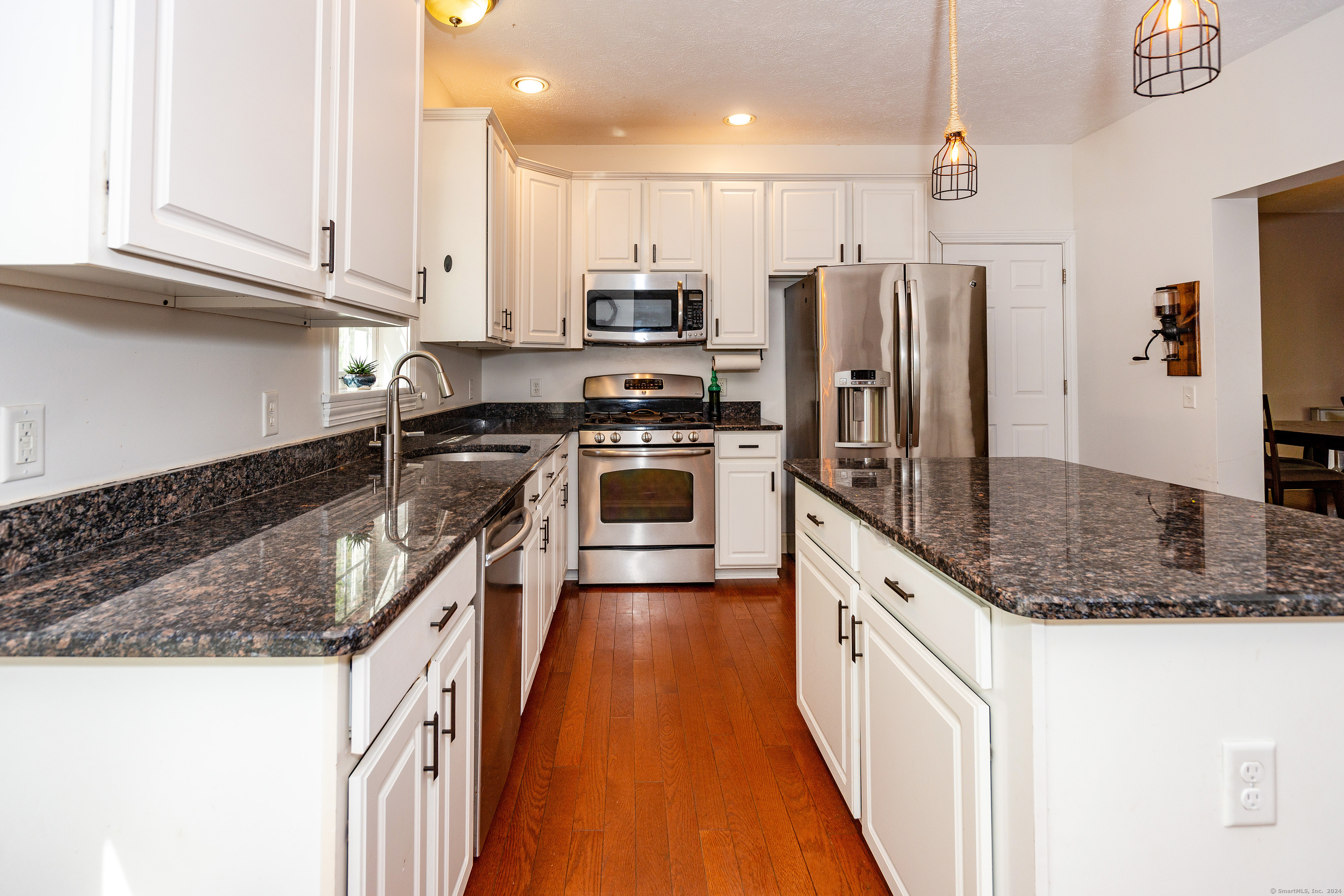 127 Massapeag Road Montville, CT 06382 - Photo 14 of 39 a kitchen with stainless steel appliances granite countertop a stove a sink and a refrigerator