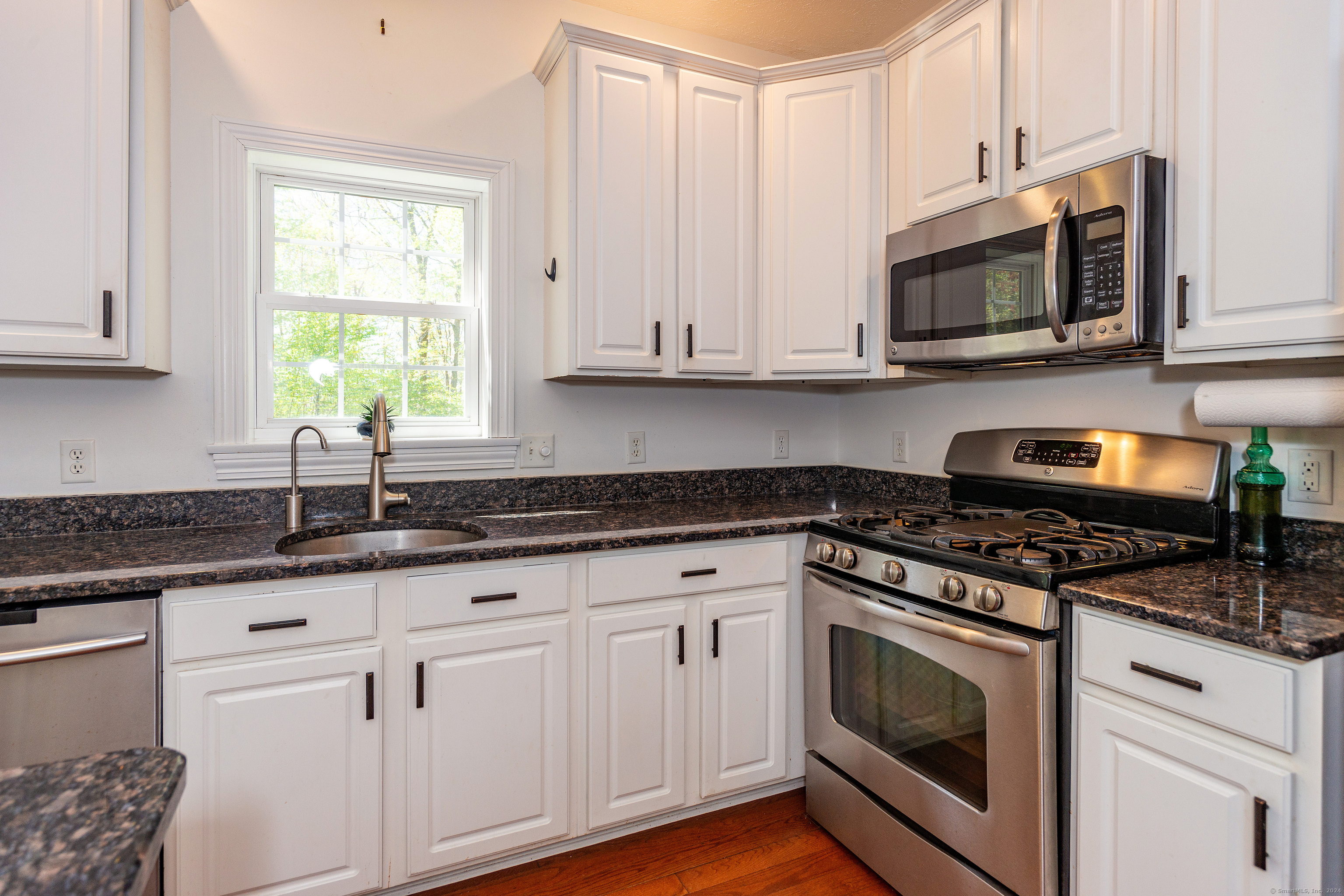 127 Massapeag Road Montville, CT 06382 - Photo 15 of 39 a kitchen with granite countertop white cabinets and appliances