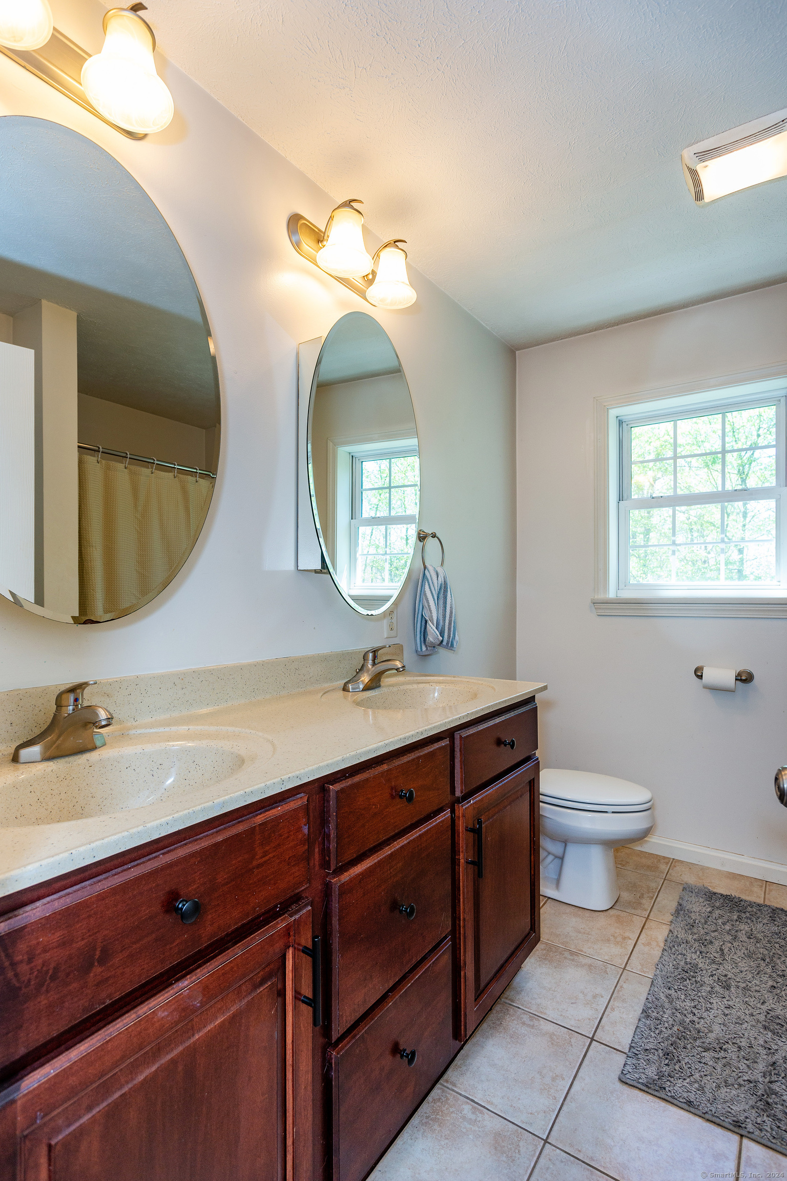 127 Massapeag Road Montville, CT 06382 - Photo 20 of 39 a bathroom with a double vanity sink and a mirror