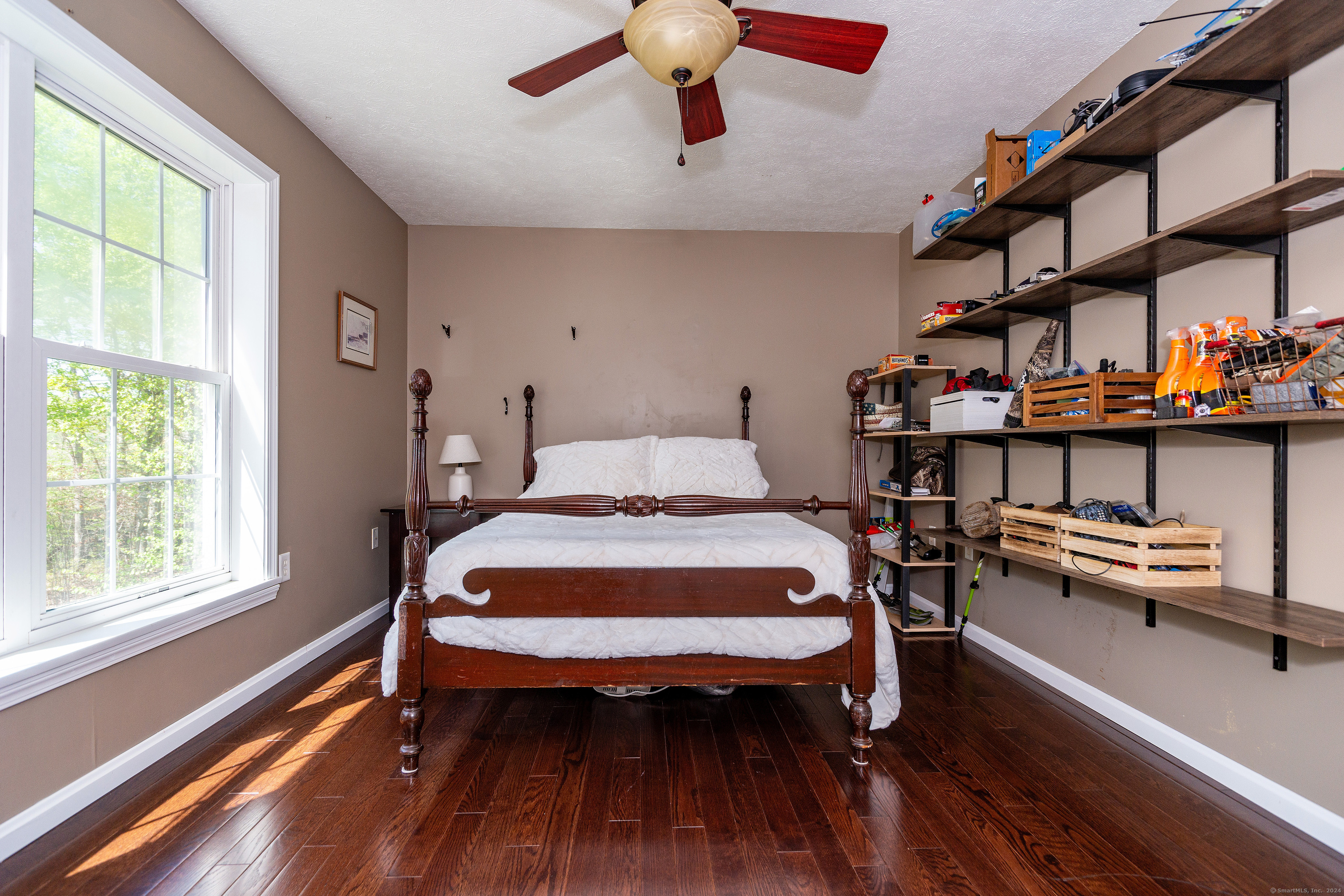 127 Massapeag Road Montville, CT 06382 - Photo 25 of 39 a bedroom with a bed and a chandelier