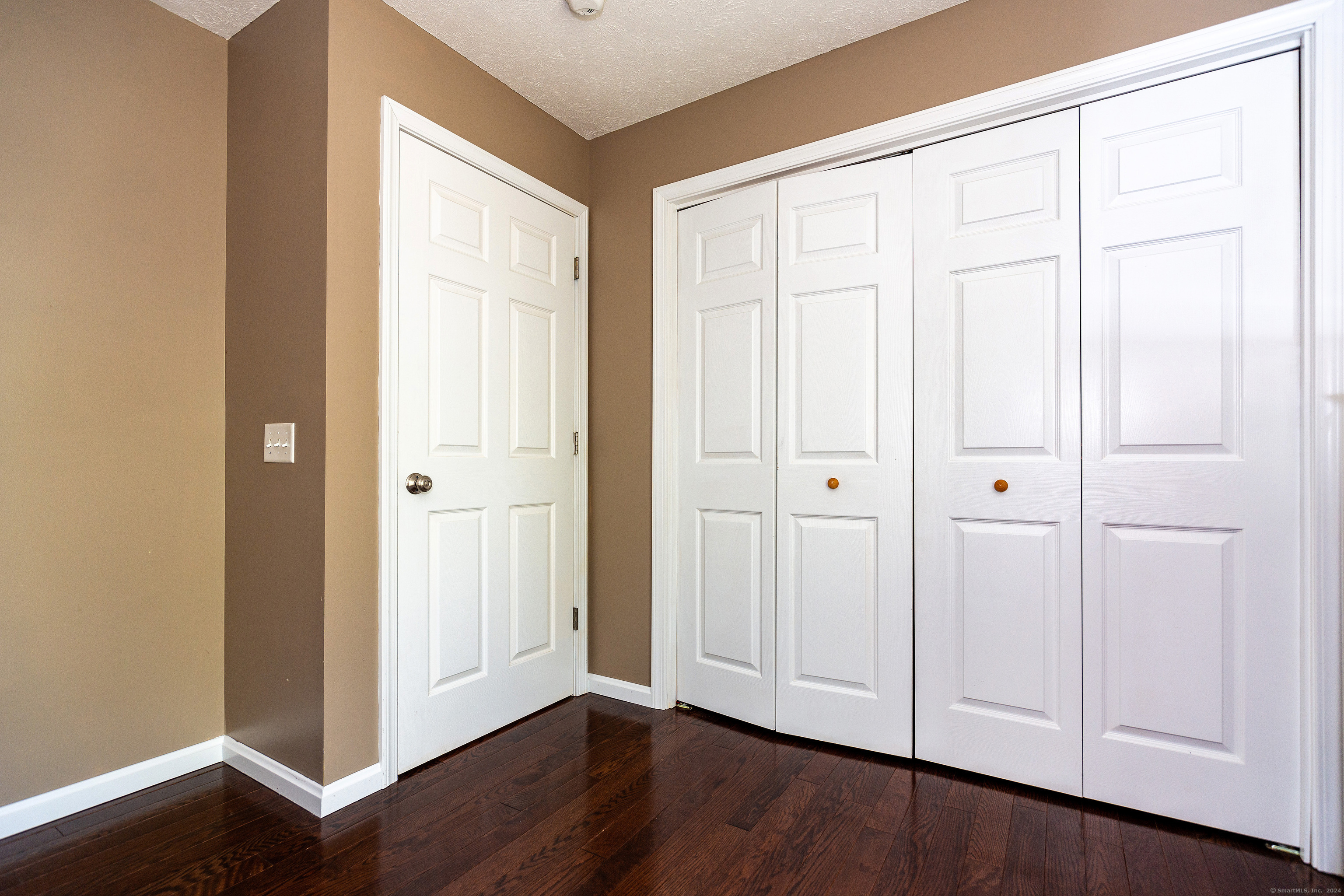 127 Massapeag Road Montville, CT 06382 - Photo 26 of 39 an empty room with wooden floor door and windows