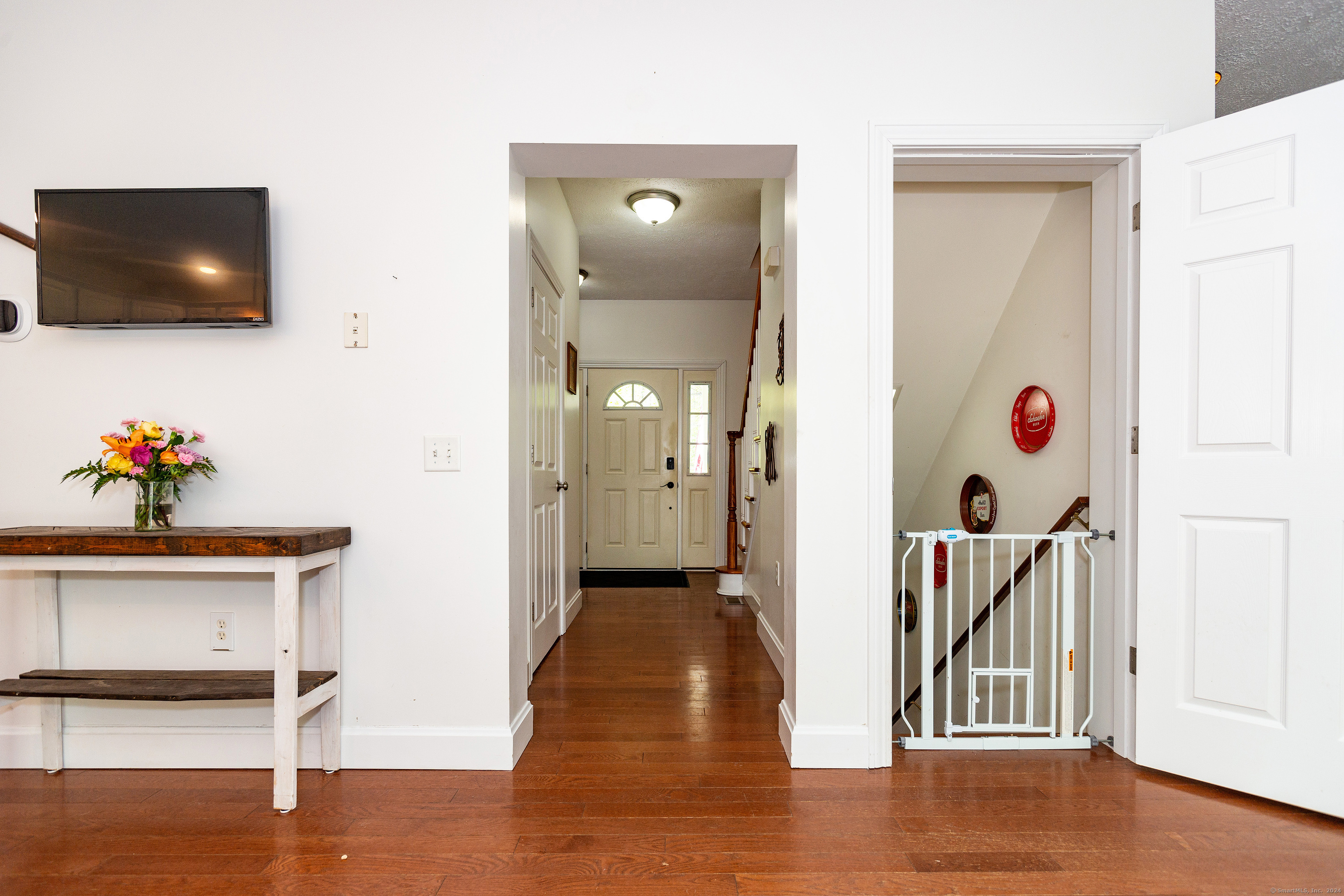 127 Massapeag Road Montville, CT 06382 - Photo 27 of 39 a view of a livingroom with wooden floor and a flat screen tv