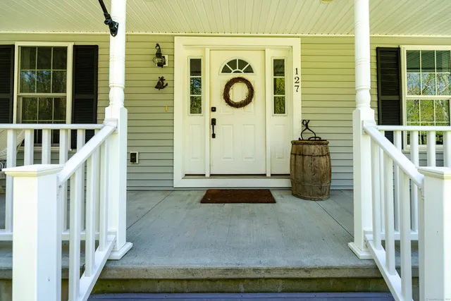a view of entryway with wooden floor and stairs