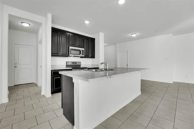 a view of a livingroom with kitchen and furniture
