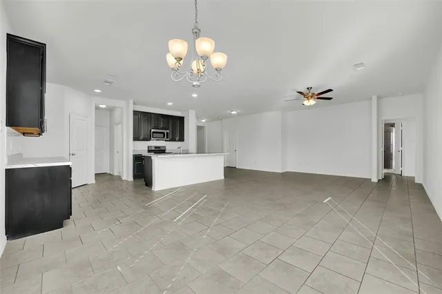 a large white kitchen with a cabinetry