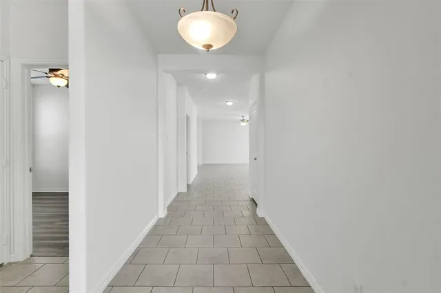 a view of a hallway with wooden floor and closet