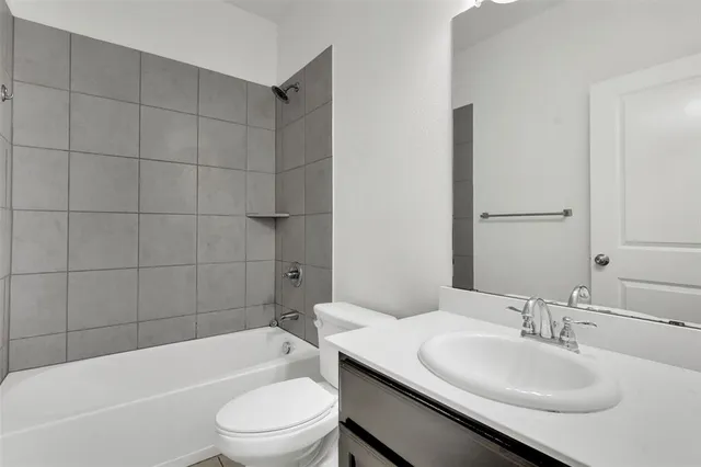 a bathroom with a sink a toilet and bathtub