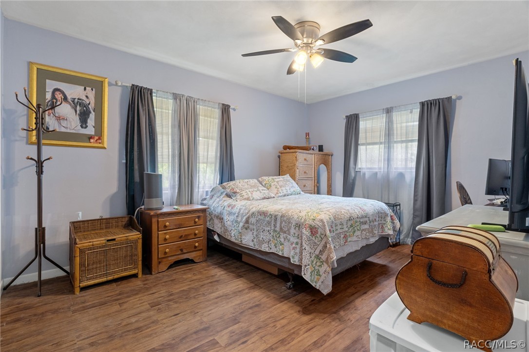 3355 South Highlands Avenue Inverness, FL 34452 - Photo 19 of 30 a bedroom with a bed and a chandelier