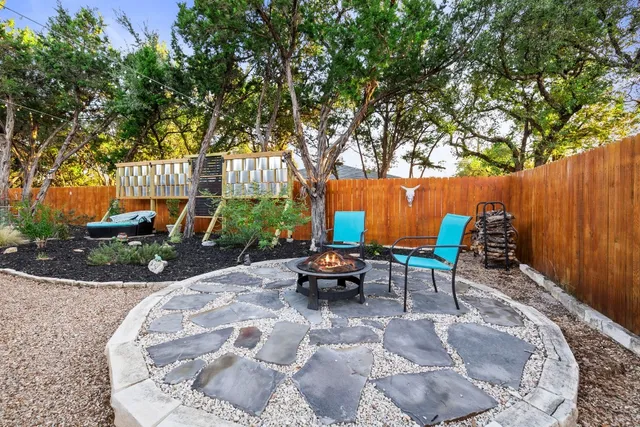 a view of a chairs and table in the backyard