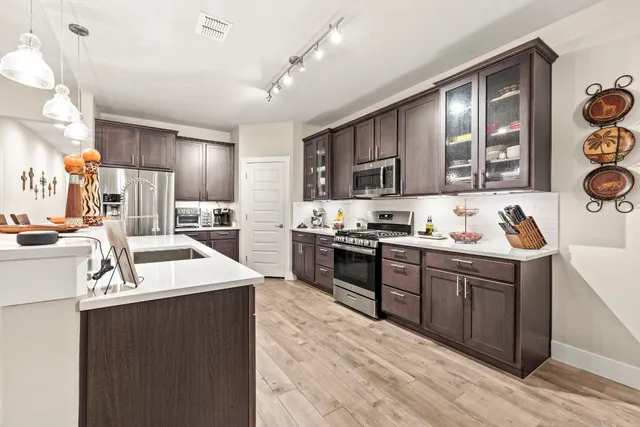 a kitchen with a sink stove and refrigerator