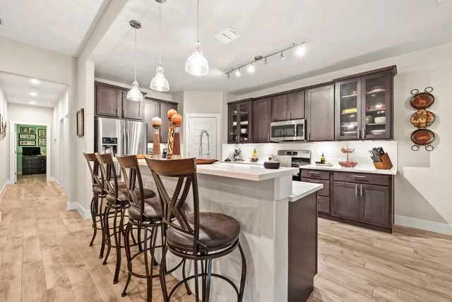 a kitchen with stainless steel appliances kitchen island granite countertop a sink and cabinets